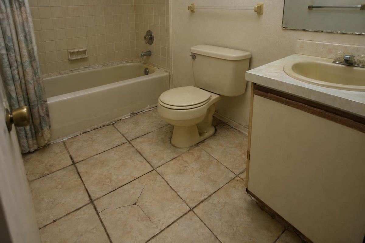 Cracked, dated bath tile, before